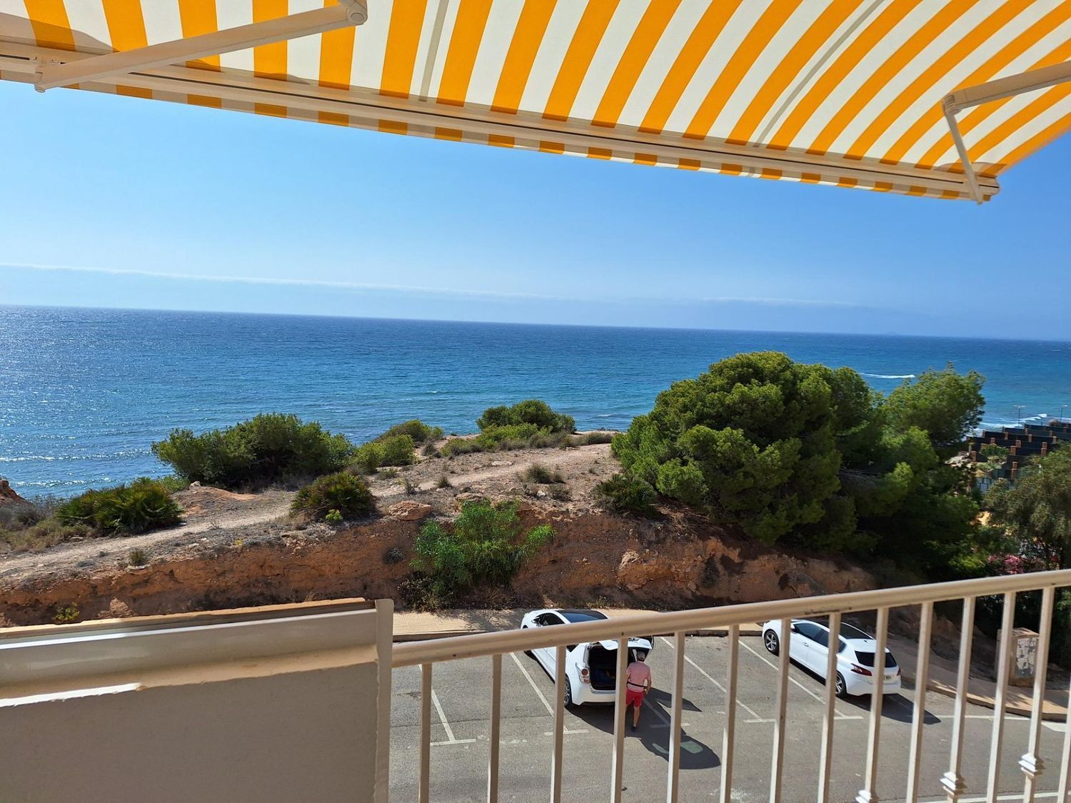 This 99 m² house offers a unique living experience on the Costa Blanca, with a privileged location just 50 meters from the beach. With direct views of the Mediterranean Sea, this is the ideal place for those seeking tranquility and the soothing sound of the sea. Main features: Distribution: 2 bedrooms (the master bedroom with sea views on the second floor and the second bedroom overlooking the pool). 2 bathrooms. Bright living room with access to a glazed terrace to enjoy panoramic sea views all year round. Fully equipped modern kitchen. Extras: Storage room of 14 m² and large subway garage. Motorized awnings for sun protection in the open spaces. Communal swimming pool with sea views. Exotic gardens around the urbanization that offer a natural and peaceful environment. Buy your house on the beachfront in Orihuela. Addurno is the real estate portal specializing in seafront properties along the coast of Spain. Find your house with sea views in Costa blanca. In Addurno we concentrate all the front line properties in Spain adapted to your needs and budget. We are committed to offer you a quality service with verified properties and real photographs. Make your appointment now!