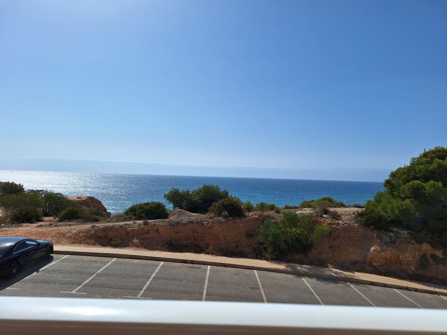 This 99 m² house offers a unique living experience on the Costa Blanca, with a privileged location just 50 meters from the beach. With direct views of the Mediterranean Sea, this is the ideal place for those seeking tranquility and the soothing sound of the sea. Main features: Distribution: 2 bedrooms (the master bedroom with sea views on the second floor and the second bedroom overlooking the pool). 2 bathrooms. Bright living room with access to a glazed terrace to enjoy panoramic sea views all year round. Fully equipped modern kitchen. Extras: Storage room of 14 m² and large subway garage. Motorized awnings for sun protection in the open spaces. Communal swimming pool with sea views. Exotic gardens around the urbanization that offer a natural and peaceful environment. Buy your house on the beachfront in Orihuela. Addurno is the real estate portal specializing in seafront properties along the coast of Spain. Find your house with sea views in Costa blanca. In Addurno we concentrate all the front line properties in Spain adapted to your needs and budget. We are committed to offer you a quality service with verified properties and real photographs. Make your appointment now!