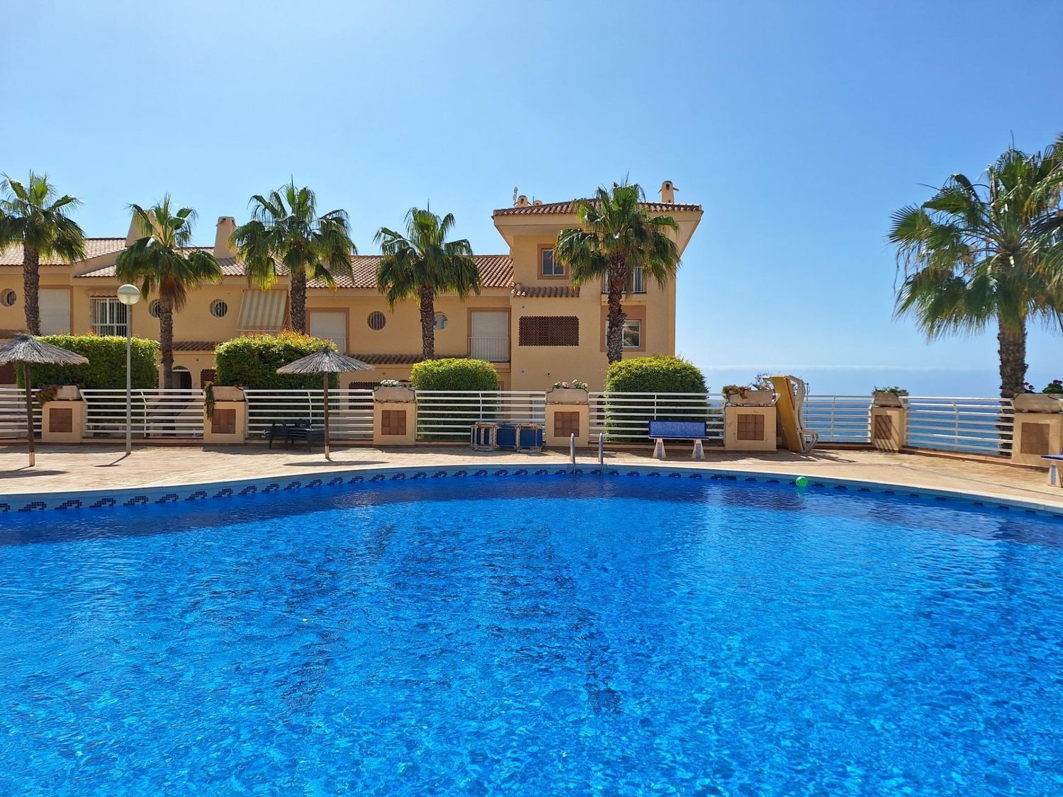 This 99 m² house offers a unique living experience on the Costa Blanca, with a privileged location just 50 meters from the beach. With direct views of the Mediterranean Sea, this is the ideal place for those seeking tranquility and the soothing sound of the sea. Main features: Distribution: 2 bedrooms (the master bedroom with sea views on the second floor and the second bedroom overlooking the pool). 2 bathrooms. Bright living room with access to a glazed terrace to enjoy panoramic sea views all year round. Fully equipped modern kitchen. Extras: Storage room of 14 m² and large subway garage. Motorized awnings for sun protection in the open spaces. Communal swimming pool with sea views. Exotic gardens around the urbanization that offer a natural and peaceful environment. Buy your house on the beachfront in Orihuela. Addurno is the real estate portal specializing in seafront properties along the coast of Spain. Find your house with sea views in Costa blanca. In Addurno we concentrate all the front line properties in Spain adapted to your needs and budget. We are committed to offer you a quality service with verified properties and real photographs. Make your appointment now!